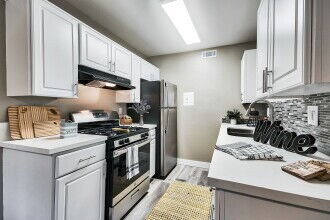 Kitchen with white cabinets and counter tops and stainless steel appliances