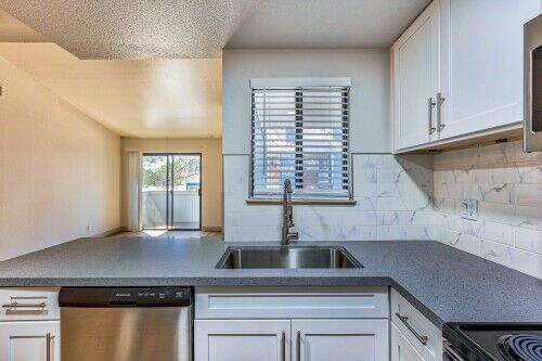 kitchen with breakfast bar and stainless steel appliances and at redfield ridge apartments